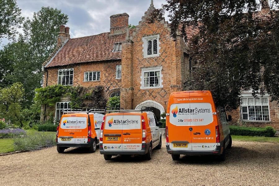 Allstar Systems plumbing and heating vans outside a Norfolk property
