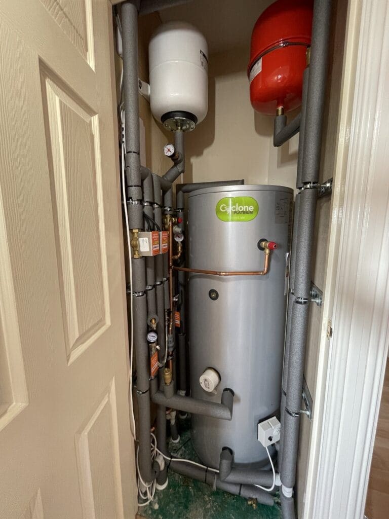 Plumber checking hot water and bathroom demand in a Long Stratton family home