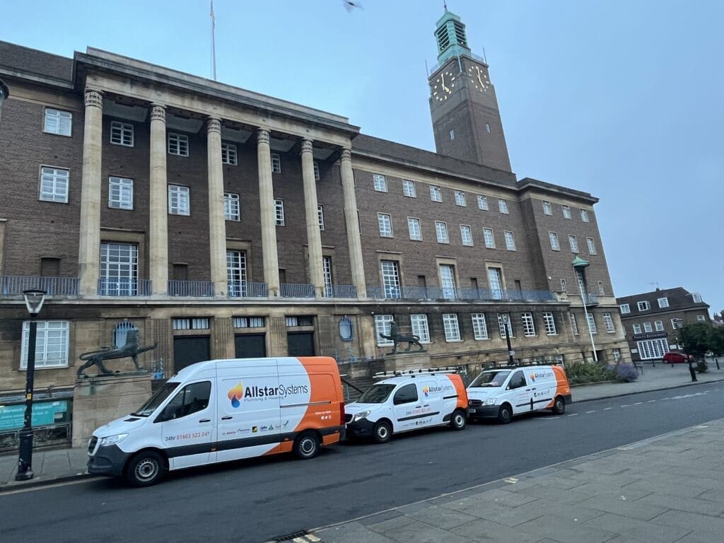 Allstar Systems emergency plumbers in Norwich with branded vans outside Norwich City Hall