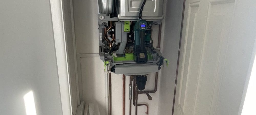 Heating engineer carrying out boiler servicing for a Brundall home