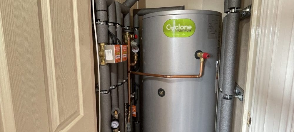 Heating engineer adjusting smart controls in a Hunstanton coastal home