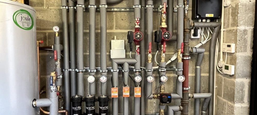 Commercial heating engineer carrying out planned maintenance at a Wymondham managed building