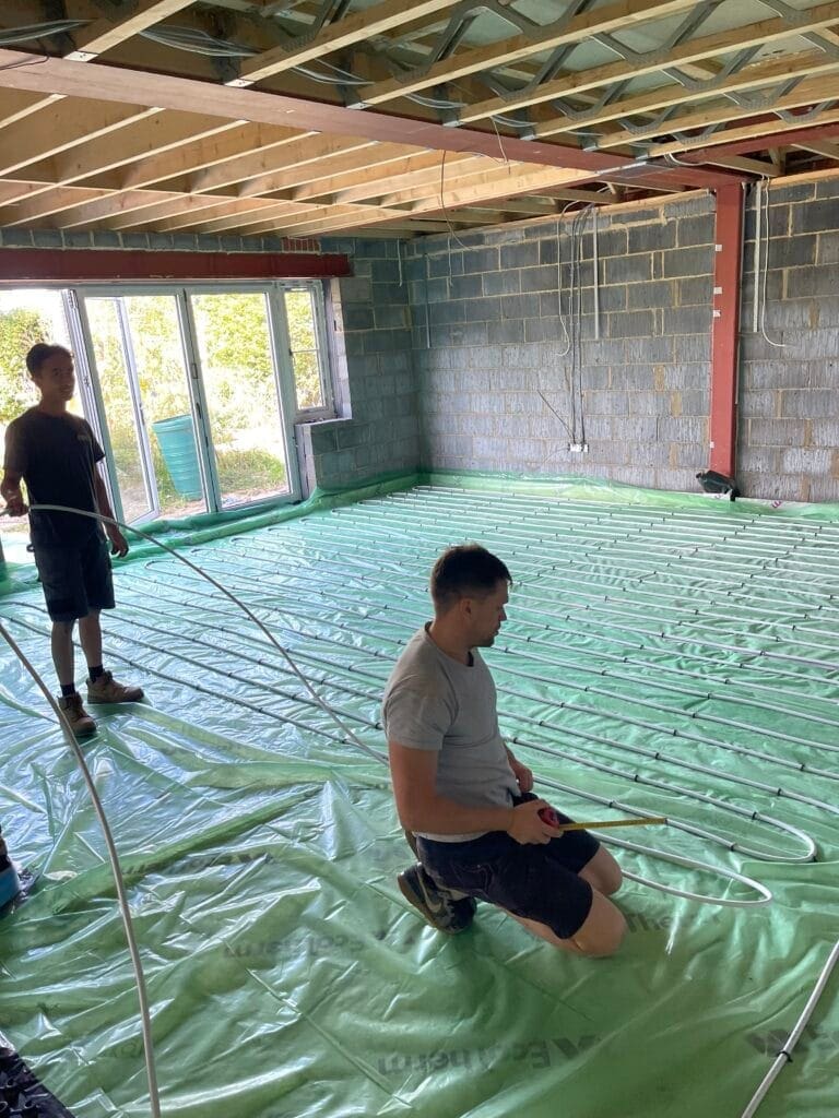 Heating engineer planning underfloor heating and smart controls in a North Walsham renovation